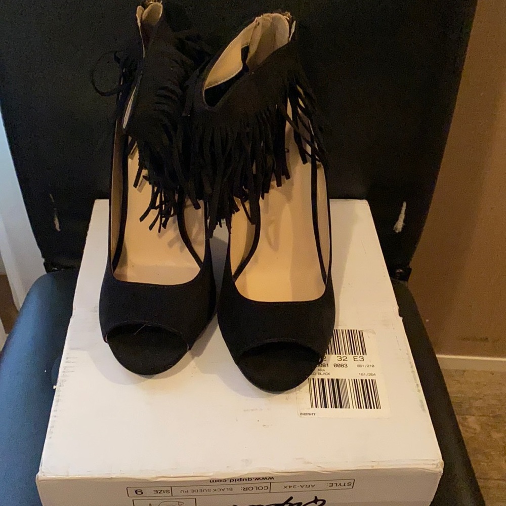 Black suede heels with fridges.